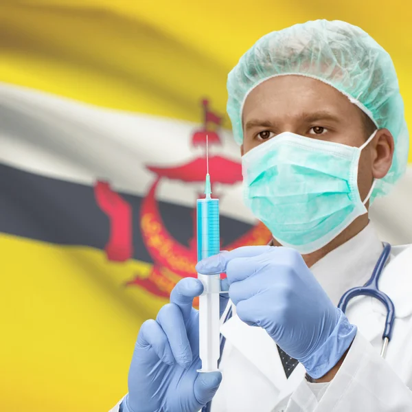 Доктор с шприц в руках и флаг серии - Бруней — стоковое фото