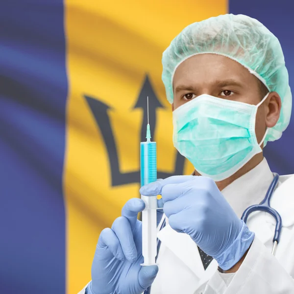 Médecin avec une seringue dans les mains et la série des drapeaux - Barbade — Photo