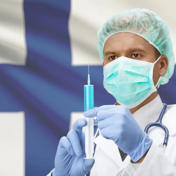 Médecin avec une seringue dans les mains et la série des drapeaux - Finlande — Photo