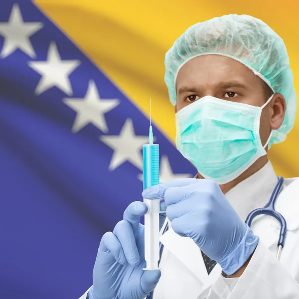 Médico con jeringa en las manos y la bandera de la serie - Bosnia y Herzegovina — Foto de Stock