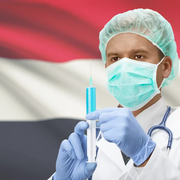 Médico con jeringa en las manos y la bandera de la serie - Yemen — Foto de Stock