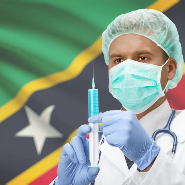 Médecin avec une seringue dans les mains et la série des drapeaux - Saint Kitts et Nevis — Photo