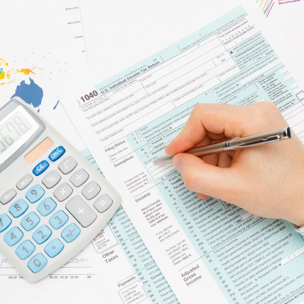 Male filling out 1040 US Tax Form with silver pen series — Stock Photo, Image