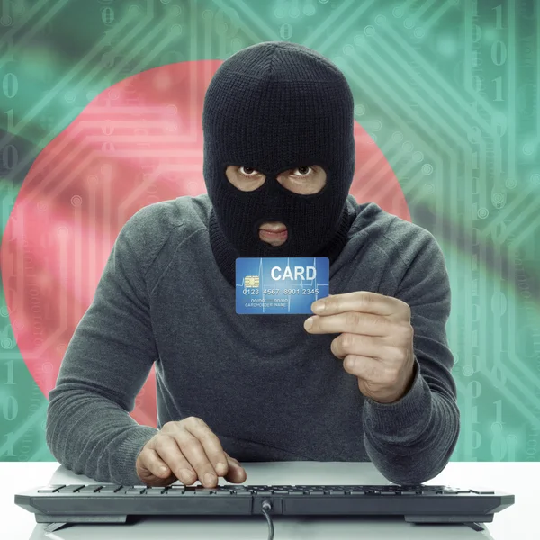 Dark-skinned hacker with flag on background holding credit card in hand - Bangladesh — Stock fotografie