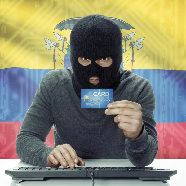 Dark-skinned hacker with flag on background holding credit card in hand - Ecuador — Stock Photo, Image