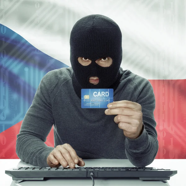 Dark-skinned hacker with flag on background holding credit card in hand - Czech Republic — Stock Photo, Image