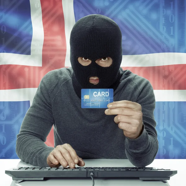 Dark-skinned hacker with flag on background holding credit card in hand - Iceland —  Fotos de Stock