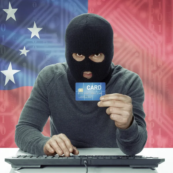 Dark-skinned hacker with flag on background holding credit card in hand - Samoa —  Fotos de Stock