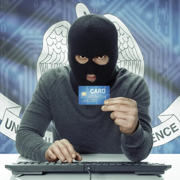 Dark-skinned hacker with USA states flag on background holding card in hand - Louisiana — Stock fotografie