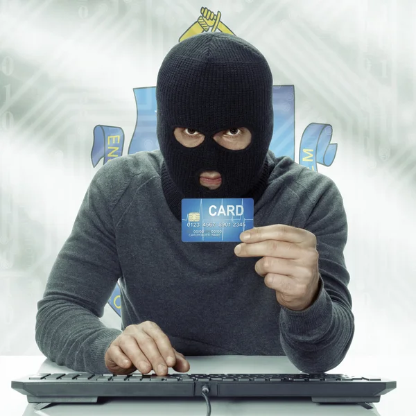 Dark-skinned hacker with USA states flag on background holding card in hand - Massachusetts — Fotografia de Stock