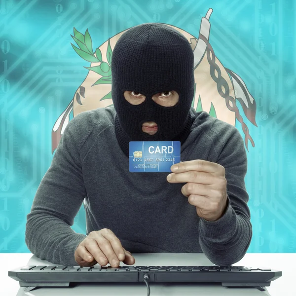 Dark-skinned hacker with USA states flag on background holding card in hand - Oklahoma — Stock Photo, Image