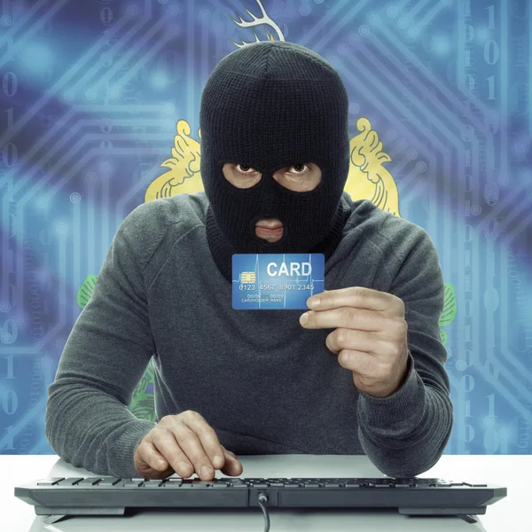 Dark-skinned hacker with USA states flag on background holding card in hand - Vermont — Stock fotografie