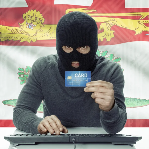 Dark-skinned hacker with Canadian province flag on background holding card - Prince Edward Island —  Fotos de Stock