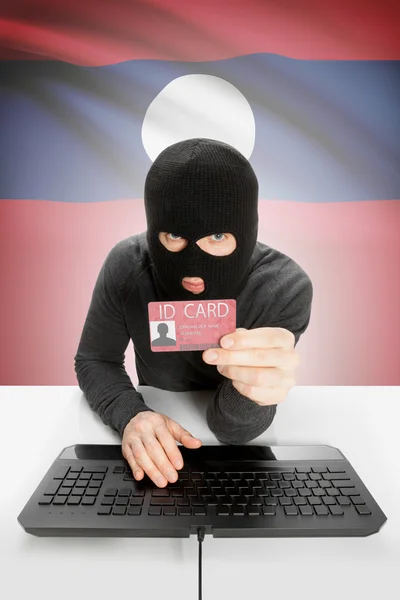 背景上有国旗的黑客手持身份证- -老挝 — 图库照片