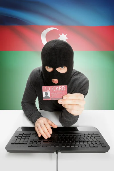 Hacker with flag on background holding ID card in hand - Azerbaijan — Stock Photo, Image