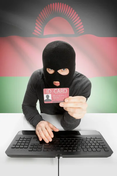Hacker with flag on background holding ID card in hand - Malawi — Stock Photo, Image