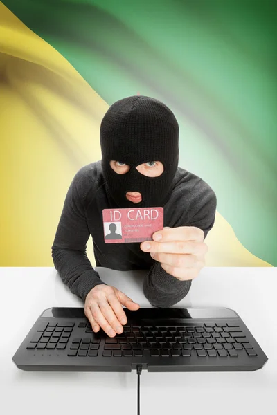 Hacker con bandiera sullo sfondo in possesso di carta d'identità in mano - Guiana francese — Foto Stock