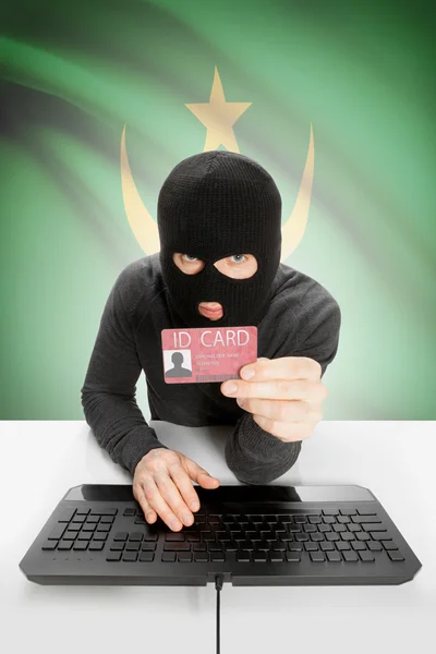 Hacker with flag on background holding ID card in hand - Mauritania — Stock Photo, Image