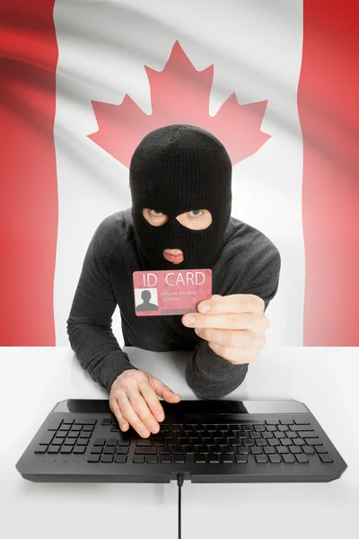 Hacker con bandera en el fondo con tarjeta de identificación en la mano - Canadá —  Fotos de Stock