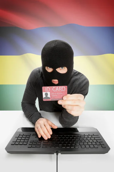 Hacker with flag on background holding ID card in hand - Mauritius — Stock Photo, Image