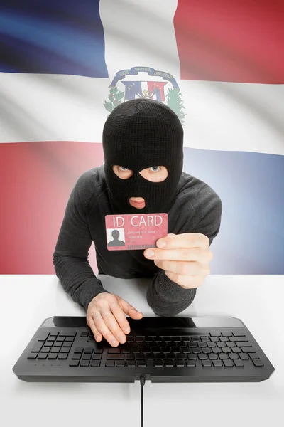 Хакер с флагом на заднем плане с удостоверением личности в руке - Доминиканская Республика — стоковое фото