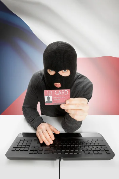Hacker with flag on background holding ID card in hand - Czech Republic — Stock Photo, Image