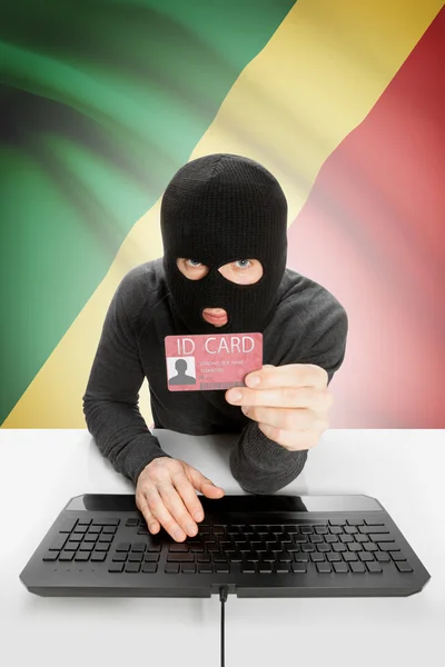 Hacker with flag on background holding ID card in hand - Congo-Brazzaville — Stock Photo, Image