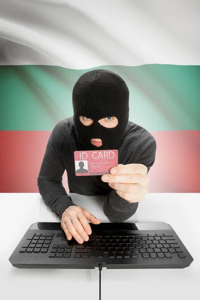 Hacker with flag on background holding ID card in hand - Bulgaria — Stock Photo, Image