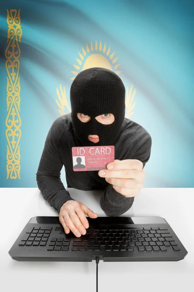 Hacker with flag on background holding ID card in hand - Kazakhstan — Stock Photo, Image