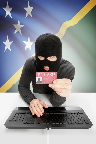 Хакер с флагом на заднем плане с удостоверением личности в руке - Соломоновы острова — стоковое фото