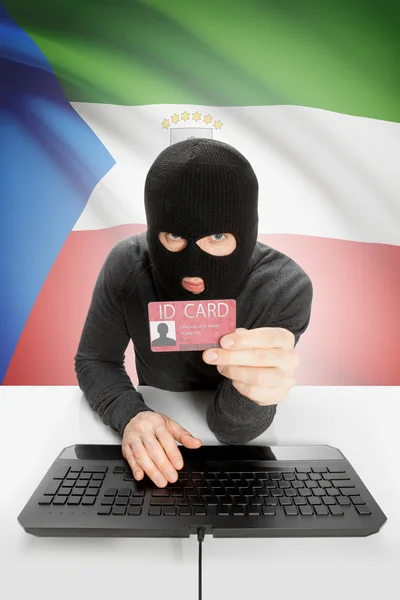 Hacker with flag on background holding ID card in hand - Equatorial Guinea — Stock Photo, Image