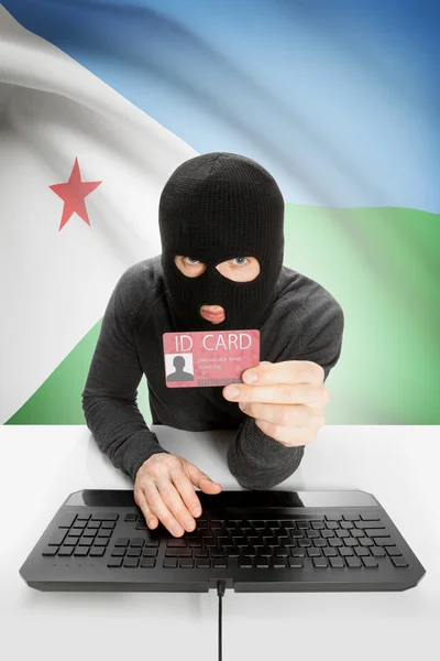 Arka planda bayrağı olan bir bilgisayar korsanı kimlik kartını elinde tutuyor - Cibuti — Stok fotoğraf