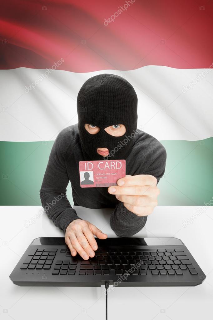 Hacker with flag on background holding ID card in hand - Hungary