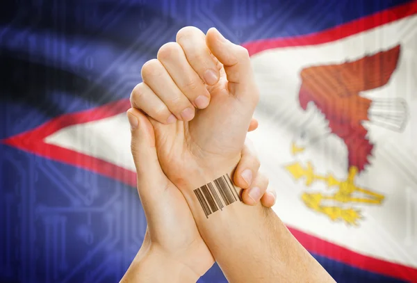 Barcode ID number on wrist and national flag on background - Aruba — Zdjęcie stockowe