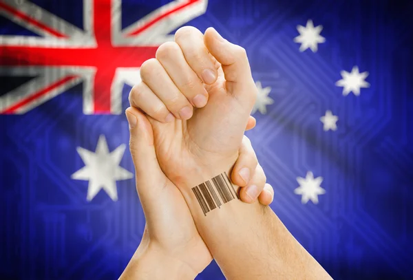 Barcode ID number on wrist and national flag on background - Australia — Foto de Stock