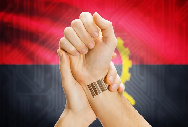 Barcode ID number on wrist and national flag on background - Angola — Stock Photo, Image