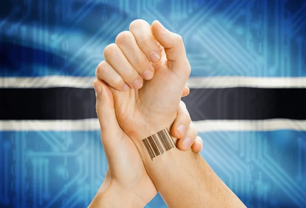 Barcode ID number on wrist and national flag on background - Botswana — 图库照片