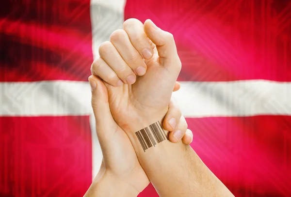 Barcode ID number on wrist and national flag on background - Denmark — ストック写真