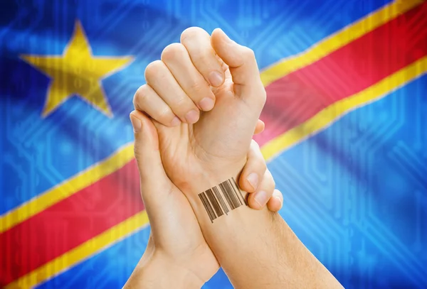 Barcode ID number on wrist and national flag on background - Congo-Kinshasa