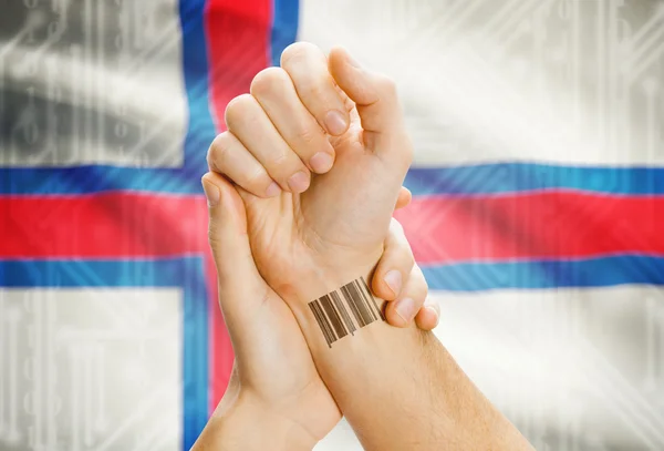 Barcode ID number on wrist and national flag on background - Faroe Islands — Fotografia de Stock