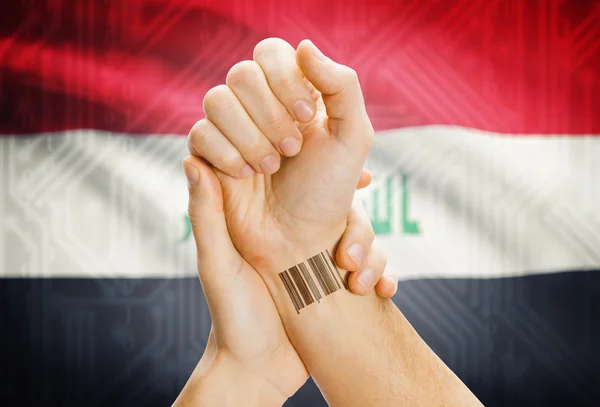 Barcode ID number on wrist and national flag on background - Iraq — Stock Photo, Image