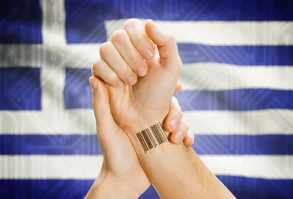 Barcode ID number on wrist and national flag on background - Greece — Stock Photo, Image