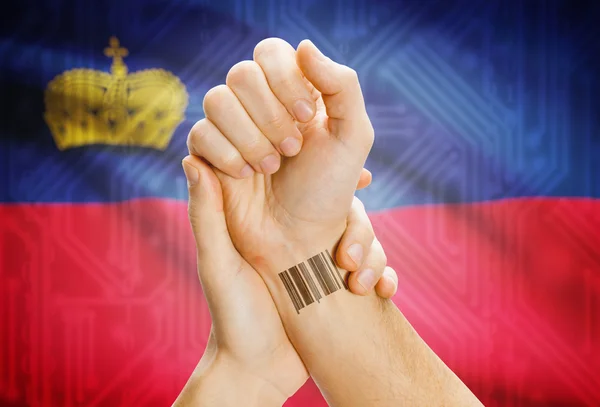 Barcode ID number on wrist and national flag on background - Liechtenstein — Zdjęcie stockowe