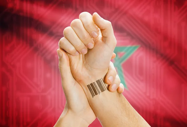 Barcode ID number on wrist and national flag on background - Morocco — Stock Photo, Image