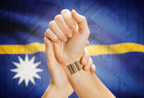 Barcode ID number on wrist and national flag on background - Nauru — Foto de Stock