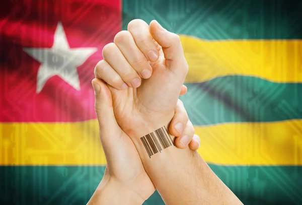 Barcode ID number on wrist and national flag on background - Togo — Fotografia de Stock
