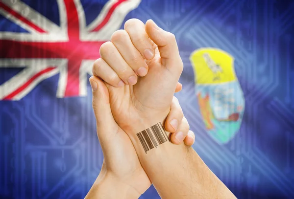 Barcode ID number on wrist and national flag on background - Ascension and Tristan da Cunha Saint Helena — Stock Photo, Image