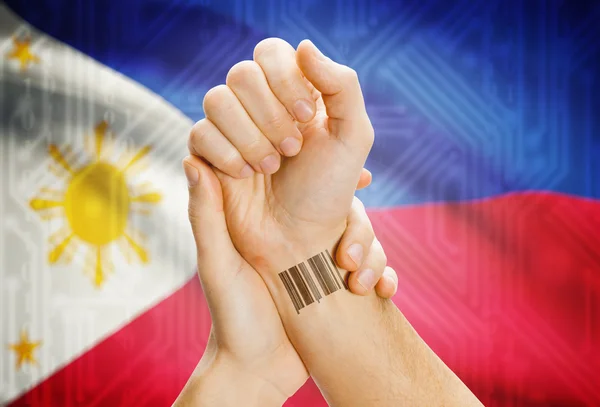 Barcode ID number on wrist and national flag on background - Philippines — Stock Photo, Image