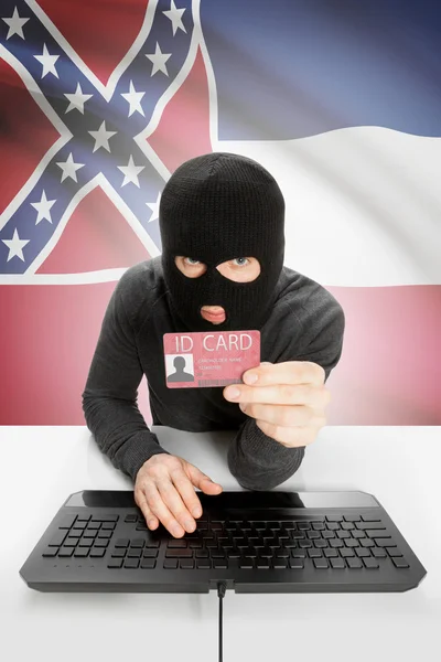 Hacker with USA states flag on background and ID card in hand - Mississippi —  Fotos de Stock