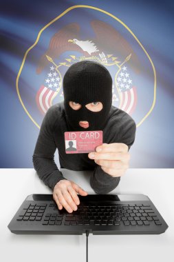 Hacker with USA states flag on background and ID card in hand - Utah